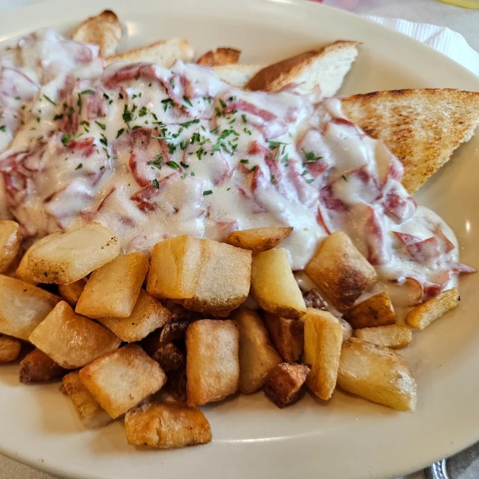 Creamed chipped beef with parsley over toast points, served with crispy home fries at Griddles Malt Shoppe.